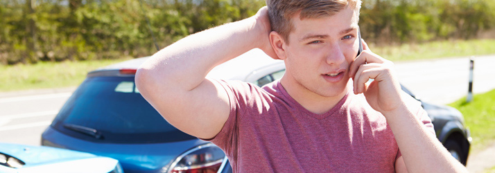 Chiropractic Denver CO Auto Accident Whiplash Young Man On Phone Chiropractic Denver CO Auto Accident Whiplash Young Man On Phone